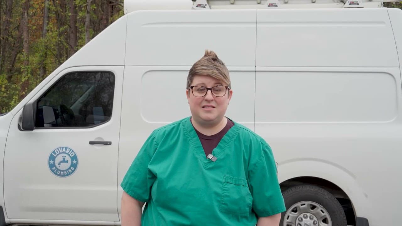 A LoVario customer standing in front of the LoVario Plumbing van