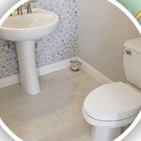 A finished bathroom with a new pedestal sink and toilet