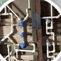 New water lines and shut-off valves roughed into a wall